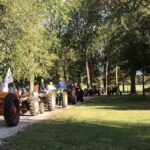 Line of tractors leaving the fair grounds.